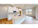 Modern kitchen featuring white cabinets, quartz countertops, and stainless steel appliances at 600 Banter Ln # 27, Cramerton, NC 28032