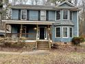Two-story house featuring a wraparound porch and a spacious yard at 701 Victorian Ln, Monroe, NC 28112