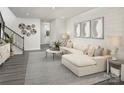 Bright living room with L-shaped sofa, large windows and neutral decor at 7232 Hodges Meadow Ln, Charlotte, NC 28213
