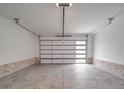 Spacious and clean garage with modern door featuring horizontal windows and brick accents on walls at 8690 Crestwood Dr, Mount Pleasant, NC 28124