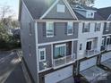 Gray townhome with balcony and two-car garage at 1028 Sharon Towns Dr, Charlotte, NC 28210