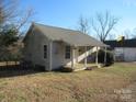 Front view of a small house with a covered porch and yard at 107 S Inman Ave, Bessemer City, NC 28016