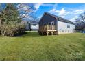 Backyard view showcasing a deck and lawn at 1077 Gibson St, Albemarle, NC 28001