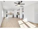 Open living room with light wood floors and ceiling fan at 1077 Gibson St, Albemarle, NC 28001