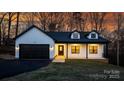 White house with black garage door and a landscaped yard at 115 Brentwood Dr, Maiden, NC 28650
