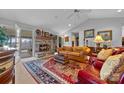 Comfortable living room with stone fireplace, vaulted ceilings, and access to screened-in patio at 124 Muirfield Dr, Kings Mountain, NC 28086