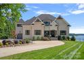 Brick house with a large driveway and manicured lawn at 132 Rollingwood Ln, Mooresville, NC 28117