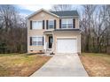 Tan two-story house with black windows and attached garage at 1529 Brookgreen Ave, Statesville, NC 28677