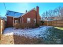 Large backyard with a wooden fence and patchy grass at 168 Park St, Statesville, NC 28677