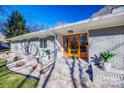 Inviting front entrance with wood door and landscaping at 2861 Sharon Rd, Charlotte, NC 28211