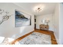 Light-filled hallway with hardwood floors and art at 2861 Sharon Rd, Charlotte, NC 28211