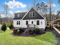 Charming home featuring white siding, brown trim, and a well-manicured lawn with mature landscaping at 4465 Red Hill Cir, Denver, NC 28037