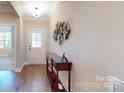 Bright entryway with hardwood floors and decorative wall art at 5002 Looking Glass Trl, Denver, NC 28037