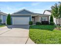 Brick and blue-sided home with a two-car garage and landscaped lawn at 5002 Looking Glass Trl, Denver, NC 28037