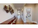 Hardwood floor hallway with access to bedrooms and living areas at 5002 Looking Glass Trl, Denver, NC 28037