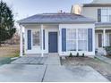 Front view of charming townhome with gray shutters and a covered porch at 5305 Esther Ln, Charlotte, NC 28214