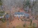 Two-story house viewed from above, surrounded by trees at 6800 April Ln, Charlotte, NC 28215