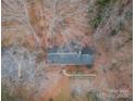 Top-down view of a ranch house on a wooded lot at 6800 April Ln, Charlotte, NC 28215