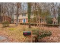 Two-story house with blue door and mailbox, surrounded by woods at 6800 April Ln, Charlotte, NC 28215