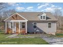 Newly built craftsman style home with gray siding, a covered porch, and a landscaped yard at 828 Cabaniss Dr, Shelby, NC 28150