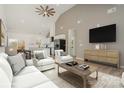 Open concept living room with vaulted ceilings, hardwood floors, and kitchen access at 828 Cabaniss Dr, Shelby, NC 28150
