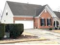 Brick home with a two-car garage and well-maintained landscaping at 9021 Gander Dr, Charlotte, NC 28277