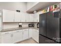 Modern kitchen with white cabinets, granite, and black appliances at 92 Saint Charles Ne Ave, Concord, NC 28025