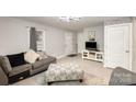Cozy living room with gray sofa and flat-screen TV at 92 Saint Charles Ne Ave, Concord, NC 28025