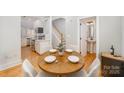 Charming dining area with round wooden table and built-in seating at 106 N Laurel Ave # 120, Charlotte, NC 28207