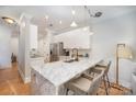Modern kitchen with white cabinets, marble countertops, and stainless steel appliances at 106 N Laurel Ave # 120, Charlotte, NC 28207