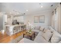 Open concept living and kitchen with island and modern appliances at 106 N Laurel Ave # 120, Charlotte, NC 28207