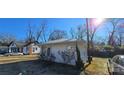White cottage with a backyard and additional building in view at 153 Saluda St, Chester, SC 29706