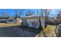 White cottage with a backyard and additional building in view at 153 Saluda St, Chester, SC 29706