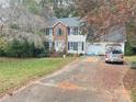 Two-story house with driveway, landscaping, and attached garage at 2328 Londonderry Dr, Gastonia, NC 28056