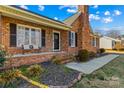 Brick front porch with walkway, landscaping, and a brick chimney at 2359 Ellerbe Dr, Kannapolis, NC 28083