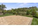 A spacious brick patio and an extensive lawn create a serene backyard retreat at 253 Stone Mountain Way, Denver, NC 28037