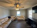 Bright living room featuring light beige couches and a large TV at 2805 N Main St, Kannapolis, NC 28081