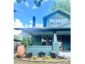 Charming home featuring a covered front porch with inviting greenery, brick accents, and a cozy, welcoming atmosphere at 3317 Ritch Ave, Charlotte, NC 28206