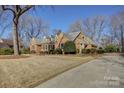 Brick house with a long driveway and mature trees at 4414 Wyman Ln, Charlotte, NC 28226