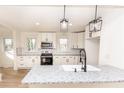 Modern kitchen with white cabinets and granite countertops at 751 N Miller Ave, Statesville, NC 28677