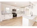 Renovated kitchen, featuring white cabinets and stainless steel appliances at 751 N Miller Ave, Statesville, NC 28677