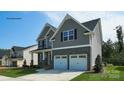 Two-story house with gray siding, stone accents, and a two-car garage at 8016 Plymouth Dr, Sherrills Ford, NC 28673