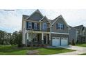 Two-story house with gray siding, stone accents, and a two-car garage at 8016 Plymouth Dr, Sherrills Ford, NC 28673