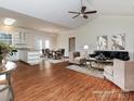 Open living space with vaulted ceiling, hardwood floors, and a modern kitchen at 9107 Dogwood Ridge Dr, Charlotte, NC 28227