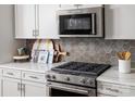 Modern kitchen with stainless steel appliances and hexagon tile backsplash at 9400 Munsing Dr # 147, Charlotte, NC 28269