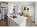 Modern kitchen with large island, white cabinets, and quartz countertops at 9400 Munsing Dr # 147, Charlotte, NC 28269