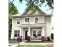 Inviting two-story home with a cozy front porch, complemented by mature landscaping and a serene neighborhood setting at 9415 Rosalyn Glen Rd, Cornelius, NC 28031