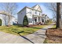 Beautiful home featuring well-maintained landscaping and classic architectural details on a sunny day at 9415 Rosalyn Glen Rd, Cornelius, NC 28031