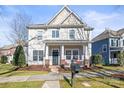 Inviting two-story home featuring a classic front porch, well-kept lawn, and traditional architectural details at 9415 Rosalyn Glen Rd, Cornelius, NC 28031