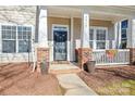 Inviting home entrance with a cozy porch, brick accents, and well-maintained landscaping at 9415 Rosalyn Glen Rd, Cornelius, NC 28031